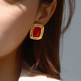 Close-up of geometric rectangular earrings with soft corners